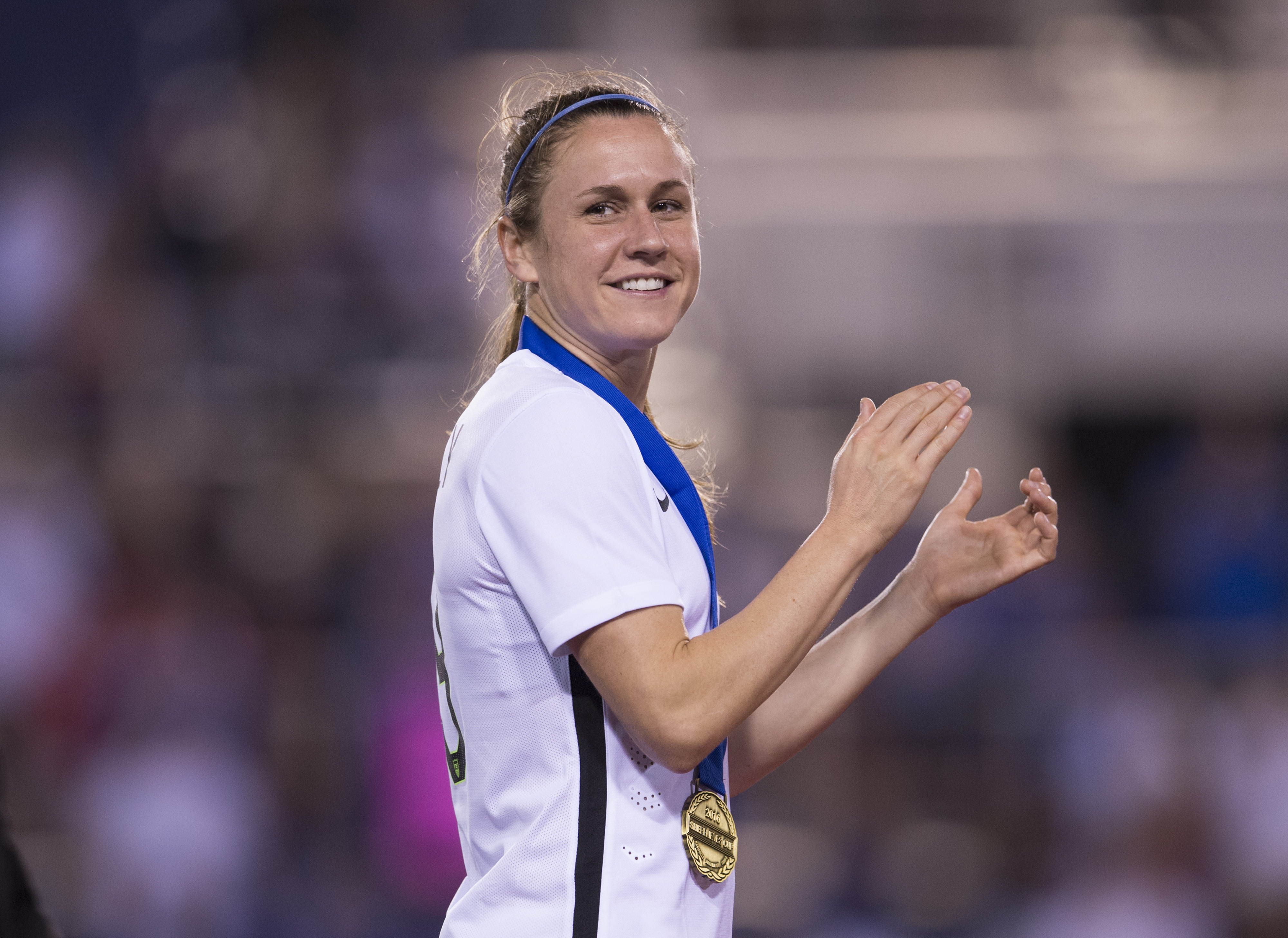 A soccer player (Heather O'Reilly) in the white kit of the US Women's National Team during a game.